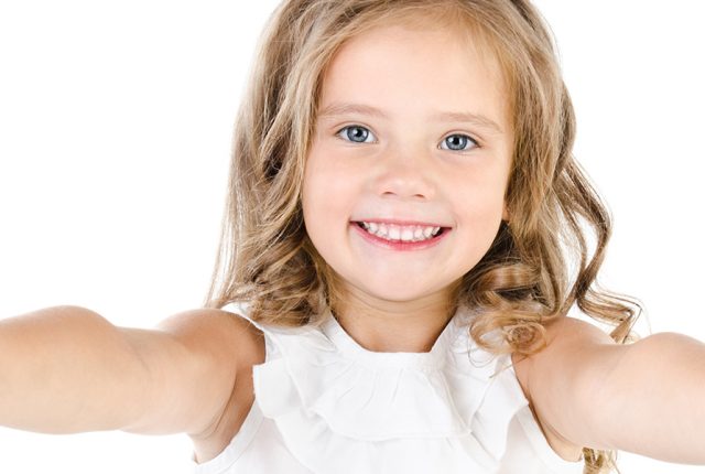 Happy cute little girl with two finger up